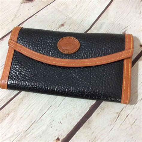 The long strap measures 11. . Dooney and bourke wallet vintage